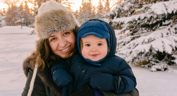cute baby and mom in winter snow
